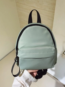 Mint green nylon mini backpack for women featuring black zippers and a lightweight design