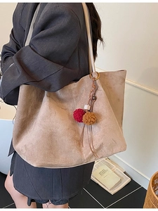 Minimalist large khaki tote bag in soft matte suede with plush ball charm detail