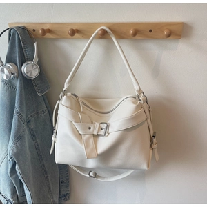 Detail of white lychee pattern tote bag with metal buckle and adjustable straps