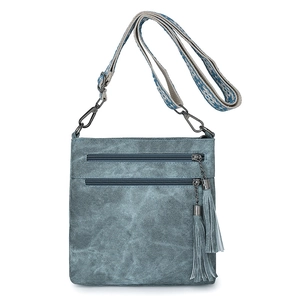 Front view of blue denim crossbody bag with dual zippers and woven guitar strap