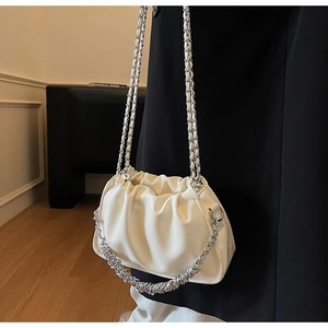 Detailed view of white pleated cloud bag featuring premium silver metal chain strap