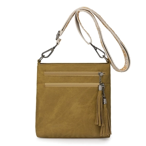 Detailed view of olive crossbody bag featuring multi-zipper pockets and ethnic wide strap