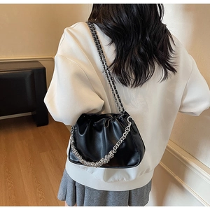 Detail of black pleated cloud bag with silver chunky chain and leather strap