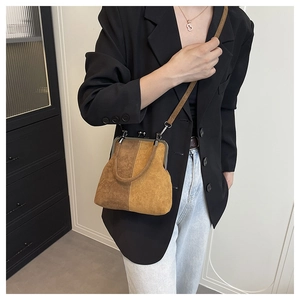 Retro bicolor suede shell bag with metal frame clasp and detachable shoulder strap detail