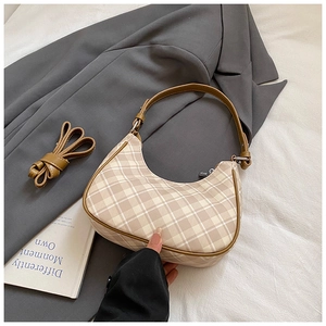 Detail view of checkered hobo bag with leather trim and removable shoulder strap