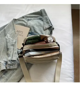 Top view of spacious interior storage compartment in beige nylon crossbody bag