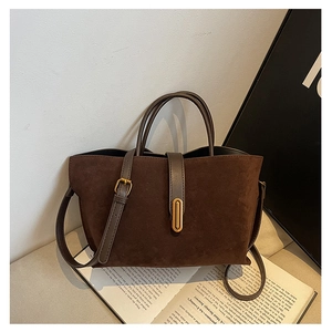 Detailed view of matte dark brown retro tote bag with vintage gold metal buckle accent