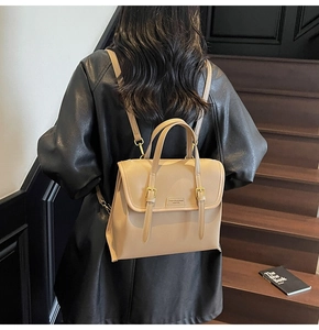 Detailed back view of a person wearing a beige and brown PU leather vintage backpack