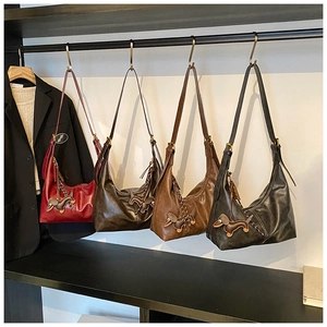 Detail showing four retro hobo bags in vintage leather with dachshund charms