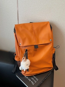 Large orange nylon backpack with flap closure and cute white plush lamb pendant