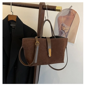 Detail of vintage dark brown frosted leather tote with metallic gold buckle and strap