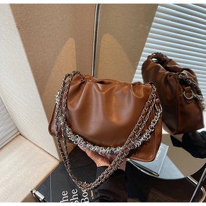 Detail of brown pleated cloud bag with chunky silver chain and soft leather texture
