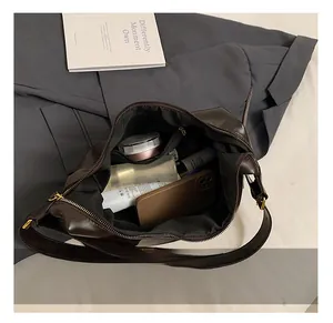 Interior view showing the large storage capacity of the vintage leather shoulder bag