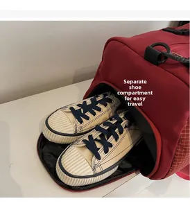 Detail of dark red travel bag featuring a separate ventilated shoe compartment