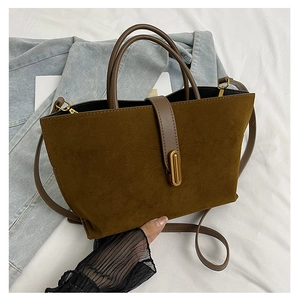 Detail of vintage brown frosted leather tote bag with golden metal twist lock and strap