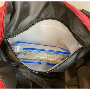 Detail of waterproof dry and wet separation pocket inside the red travel gym bag