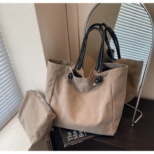 Detail of khaki canvas tote bag set with knotted shoulder strap and matching pouch
