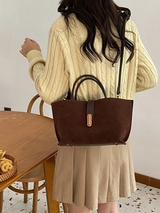 Brown frosted suede tote bag with adjustable shoulder strap and gold metal buckle