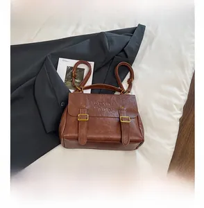 Detail view of retro brown PU leather texture and embossed text on multi-use backpack
