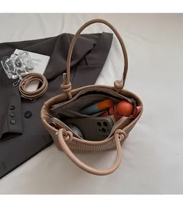 Interior view of pleated bucket bag showing capacity for phone and umbrella