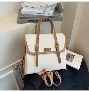 Detailed view of the dual-use contrast color backpack with leather texture and metal buckles