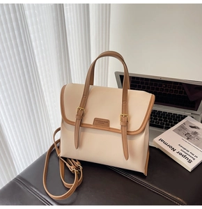Detail of vintage cream and brown contrast commuter backpack with buckle straps