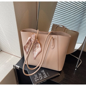 Detailed close-up of nude pink tote bag with lychee grain texture and silk scarf detail