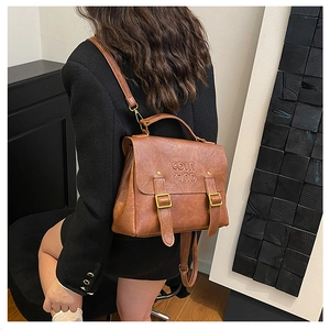 Brown vintage multi-purpose backpack featuring flap cover and gold-tone hardware detail