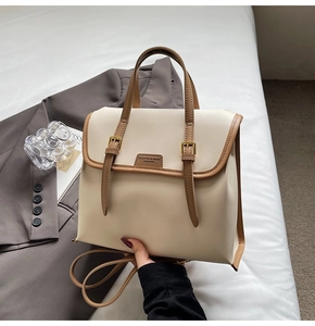 Detail showing premium beige and brown PU leather texture and stylish front flap design
