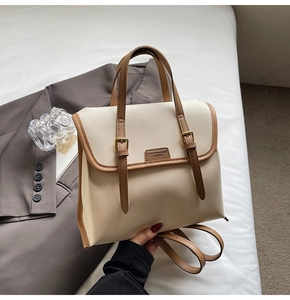 Detail of vintage beige and brown patchwork backpack with leather straps and buckles