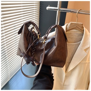 Detailed macro view of dark brown faux leather bag with vintage texture and zipper