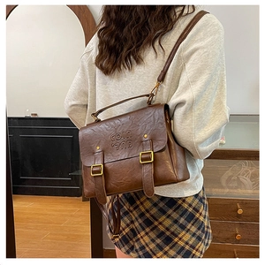 Detailed close-up of vintage brown leather bag with embossed COLN 700 lettering