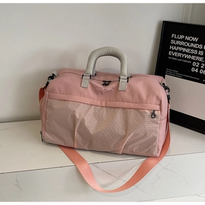 Close-up of pink fitness travel bag with mesh pocket and NINGJIA embroidery detail