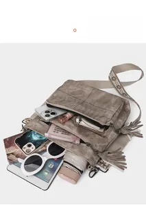 Detail view of large capacity vintage crossbody bag interior with wide embroidered strap