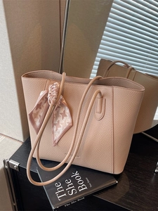 Pale pink lychee grain leather tote bag with houndstooth silk scarf on the handles