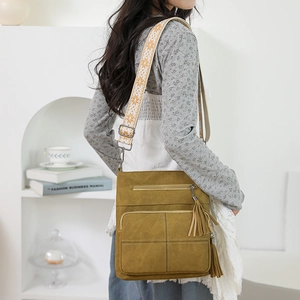 Detail of mustard yellow canvas crossbody bag with jacquard embroidered wide strap