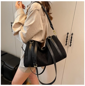 Dettaglio della borsa tote in pelle scamosciata nera opaca con finiture dorate