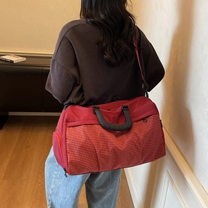 Red large capacity travel bag with checkered pattern and adjustable shoulder strap