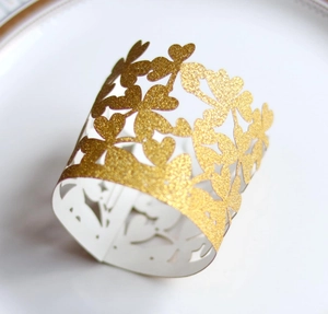 Dettaglio di coprilume dorati con glitter e motivi traforati di farfalle e cuori