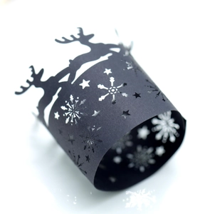 Intricate laser-cut black reindeer and snowflake hollow napkin ring for festive tables
