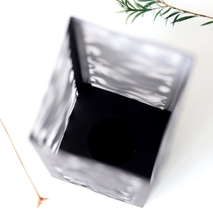 Detail view of laser-cut black hollow lampshade featuring intricate geometric patterns