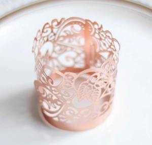 Rose gold laser-cut hollow tea light candle wrap with elegant floral lace pattern