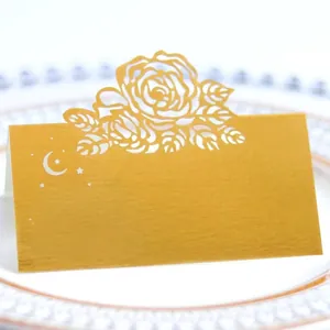 Golden laser-cut place card with rose hollow design and moon star accents for wedding decor