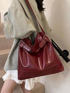 Large burgundy shoulder tote bag with retro buckle details for stylish office commuting