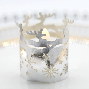 Silver hollow Christmas candle shade with reindeer and snowflake laser-cut patterns