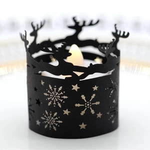 Black Christmas tea light holder with reindeer and snowflake cutout patterns and LED light