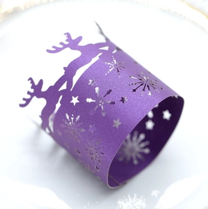 Macro view of purple glitter reindeer and snowflake laser cut paper napkin ring