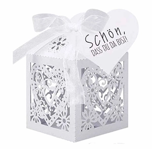 Laser-cut white wedding favor box with heart patterns, silk ribbon and German gift tag