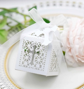 Elegant white laser-cut cross favor box with white ribbon for wedding or baptism