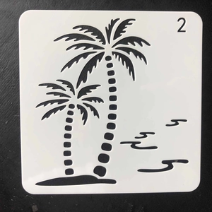 Detail of square white PET stencil with laser-cut coconut trees and waves for DIY painting
